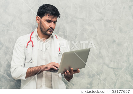 Doctor using laptop computer at the hospital. Doctor using laptop computer at the hospital. 58177697