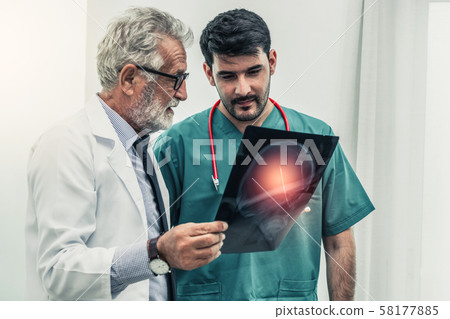 Doctor at hospital working on x ray film image. Doctor at hospital working on x ray film image. 58177885