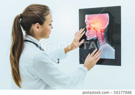 Doctor working with x ray film of patient head. 58177886
