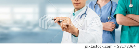 Doctor working in hospital with other doctors. 58178364