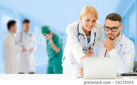 Doctor working in hospital with other doctors. 58178503