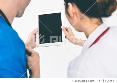 Doctors looking at data on computer at hospital. 58179062