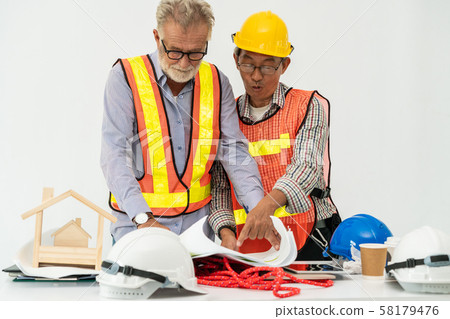Senior engineer and architect working with drawing 58179476