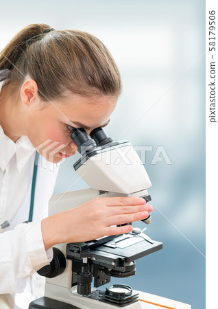 Scientist researcher uses microscope in laboratory Scientist researcher uses microscope in laboratory 58179506