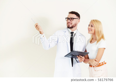 Male doctor with patient points pen at copy space. Male doctor with patient points pen at copy space. 58179766