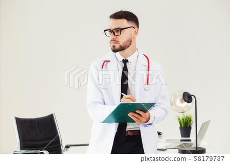 Doctor holding patients health file in hospital. Doctor holding patients health file in hospital. 58179787