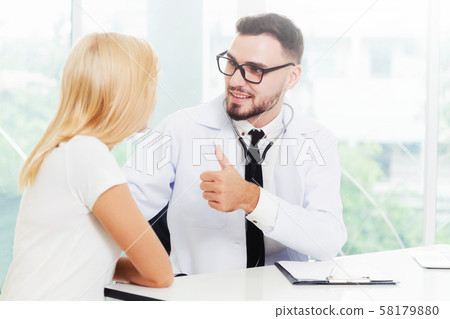 Male Doctor and Female Patient in Hospital Office 58179880