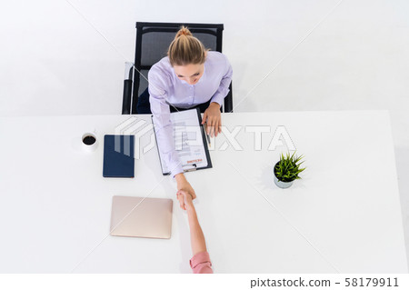 Two young business women meeting for interview. Two young business women meeting for interview. 58179911