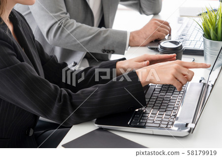 Businessman and businesswoman working in office. 58179919