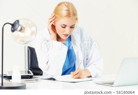 Doctor in hospital working on medical report. 58180064
