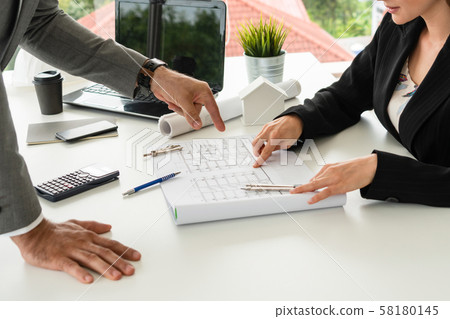 Architect and engineer working with drawing. 58180145