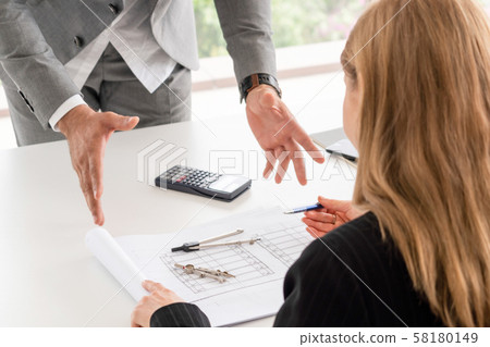 Architect and engineer working with drawing. Architect and engineer working with drawing. 58180149