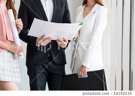 Businessman and businesswomen working in office. 58180238