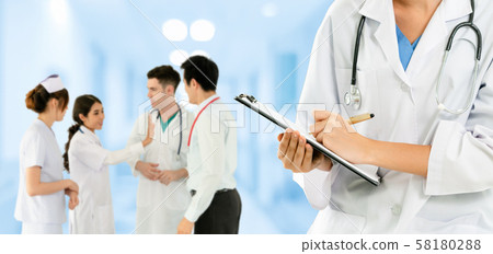 Doctor working in hospital with other doctors. Doctor working in hospital with other doctors. 58180288