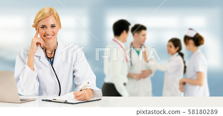 Doctor working in hospital with other doctors. Doctor working in hospital with other doctors. 58180289