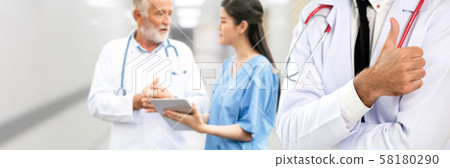 Doctor working in hospital with other doctors. Doctor working in hospital with other doctors. 58180290