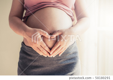 Happy pregnant woman and expecting baby at home. 58180291