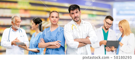 Doctor working in hospital with other doctors. 58180293