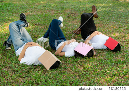 Funny students sleeping with books on their face. 58180513