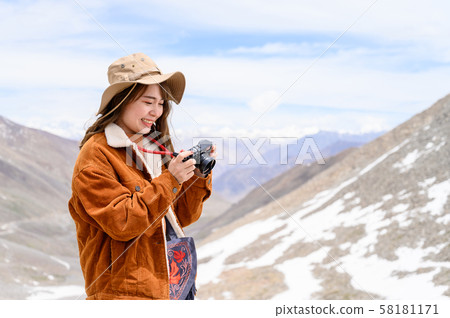 Young woman enjoy her camera in journey Young woman enjoy her camera in journey 58181171