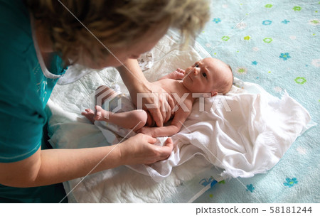 Rocking the baby in her arms at home 58181244