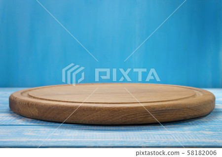 pizza cutting board at rustic wooden table Stock Photo by seregam