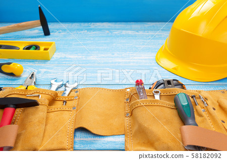 tools and instruments in belt on wooden table 58182092