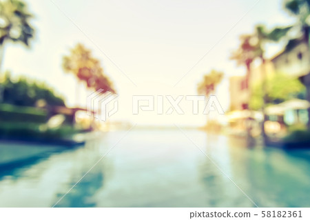 Blur summer background for resort hotel pool party with blue cool sky and tropical palm tree 58182361