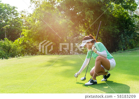 Healthy Sport.  Asian sporty woman putting golf ball 58183209
