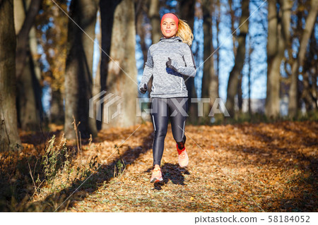 Young woman running training in autumn park 58184052