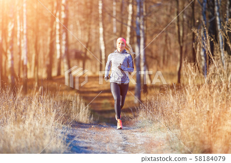 Fitness girl training running in the morning park 58184079