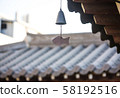 Korean traditional roof with a small bell hanging at the end of the eaves (landscape) 58192516