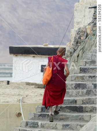A monk at ancient Tibetan temple A monk at ancient Tibetan temple 58194108