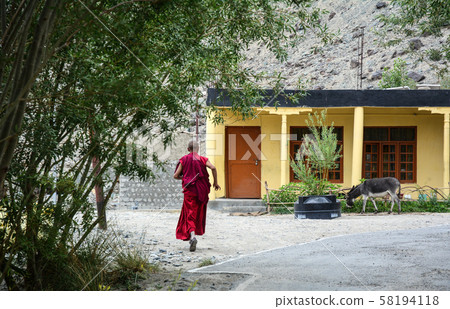 A monk at ancient Tibetan temple A monk at ancient Tibetan temple 58194118