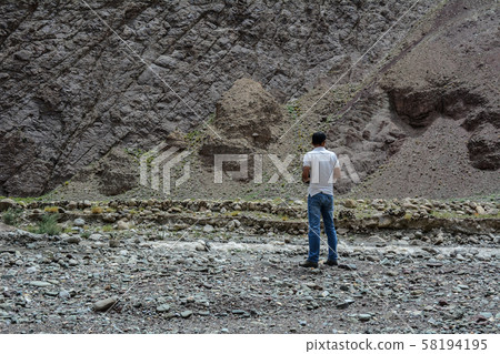 A young man stands on mountain A young man stands on mountain 58194195