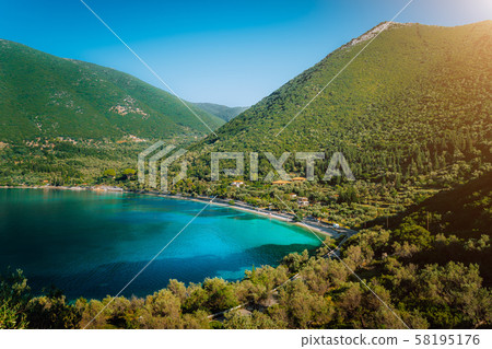 Antisamos beach on Kefalonia island, Greece. Crystal clear water, huge hills overgrown with Antisamos beach on Kefalonia island, Greece. Crystal clear water, huge hills overgrown with 58195176