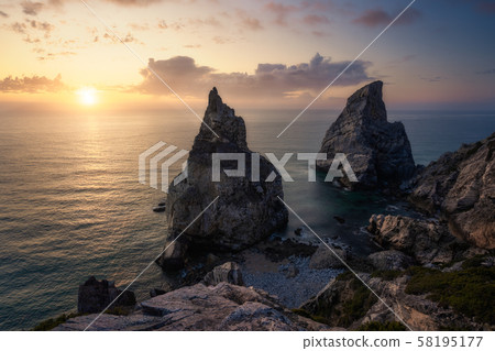 Hidden Praia Da Ursa - Ursa Beach, Sintra, Portugal. Two huge rocks rasing in evening golden sunset 58195177