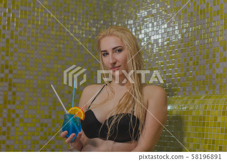 Beautiful girl has a rest in a hammam and drinks a 58196891