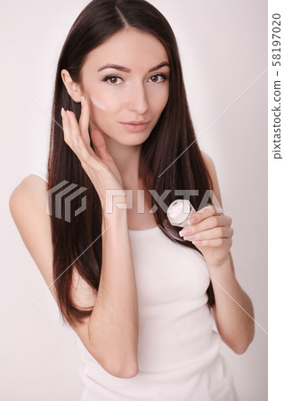 A beautiful woman asia using a skin care product, moisturizer or lotion and Skincare taking care of A beautiful woman asia using a skin care product, moisturizer or lotion and Skincare taking care of 58197020