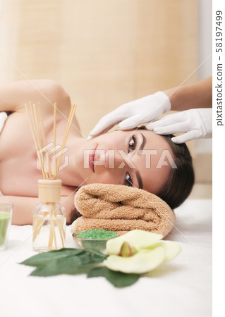 Young pretty woman enjoying face massage procedure 58197499