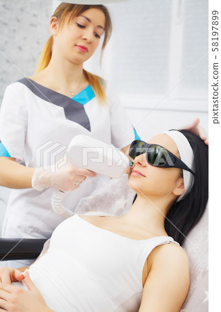 Body Care. Underarm Laser Hair Removal. Beautician Removing Hair Of Young Woman's Armpit. Laser Body Care. Underarm Laser Hair Removal. Beautician Removing Hair Of Young Woman's Armpit. Laser 58197899