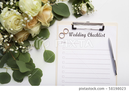 Creative wedding planning checklist with roses and rings 58198023