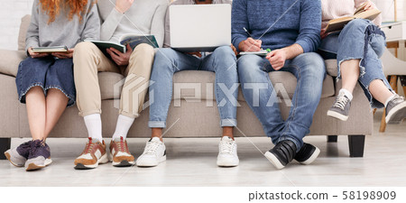 Classmates studying together, using laptop and books Classmates studying together, using laptop and books 58198909
