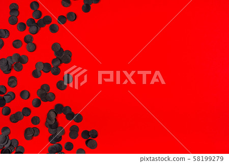 Red background with black confetty. Red background with black confetty. 58199279