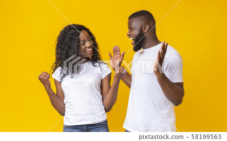 Black man and woman happily surprised with good news Black man and woman happily surprised with good news 58199563