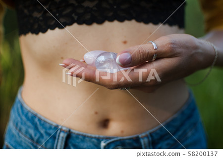 Female hands holding two yoni eggs for vumfit, imbuilding or meditation are made from pink quartz Female hands holding two yoni eggs for vumfit, imbuilding or meditation are made from pink quartz 58200137