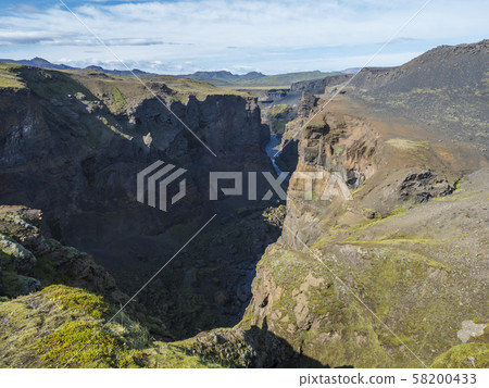 View on majestic Markarfljotsgljufur Canyon gorge and river with green moss covered hills near 58200433
