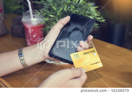 Woman shopping on the internet with smartphone and 58206079
