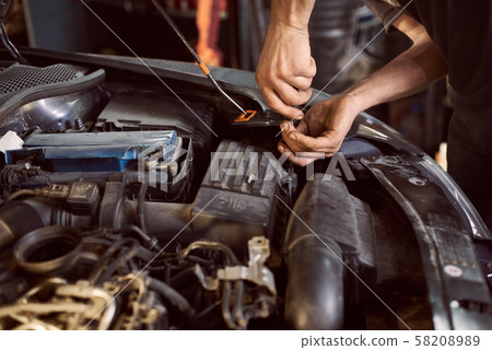 Repair man fixing car in repair station Repair man fixing car in repair station 58208989