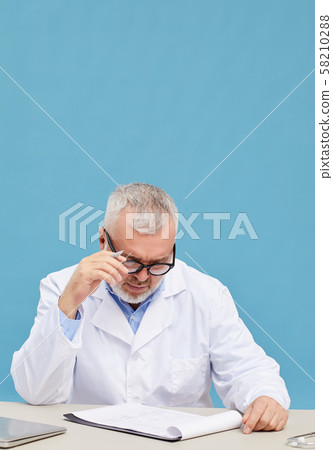 Doctor examining medical card 58210288